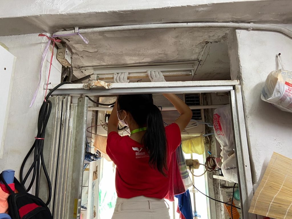 This is her visit to a subdivided flat in Kwai Chung and changing the light bulbs to LED lights to save the electricity expenses for households